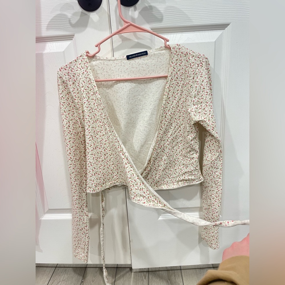 Brandy Melville long sleeve wrapped top with a floral pattern.